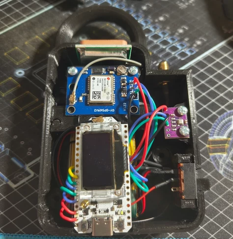 View of a Heltec LoRa radio assembly along with several supplemental modules mounted in a 3d printed case.